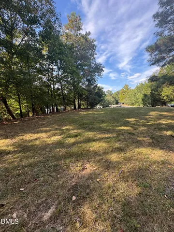 a view of a field with an trees
