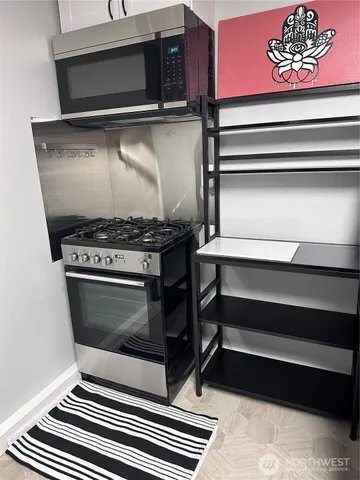a stove top oven sitting inside of a kitchen