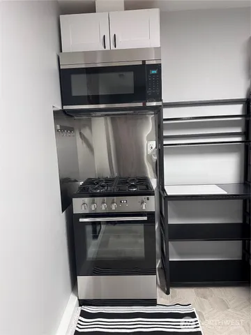 a stove top oven sitting inside of a kitchen