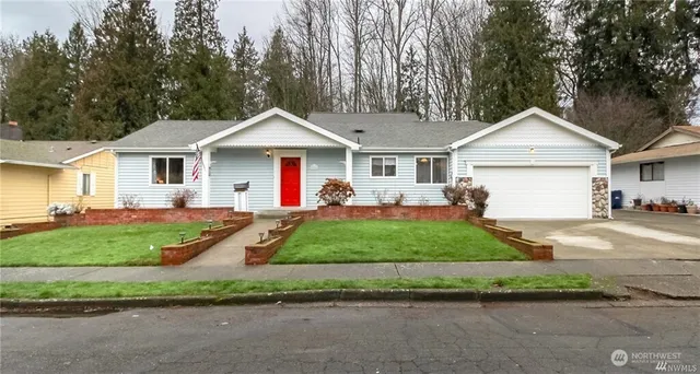 a front view of a house with a yard and garage