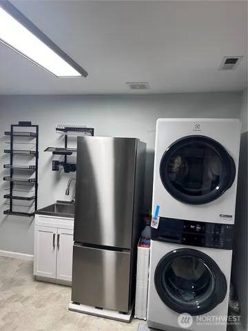 a kitchen with a refrigerator and cabinets