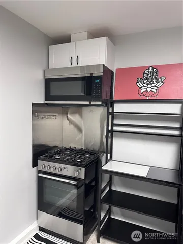 a stove top oven sitting inside of a kitchen