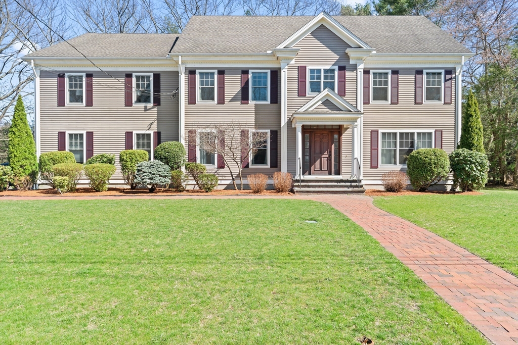 a front view of a house with a yard