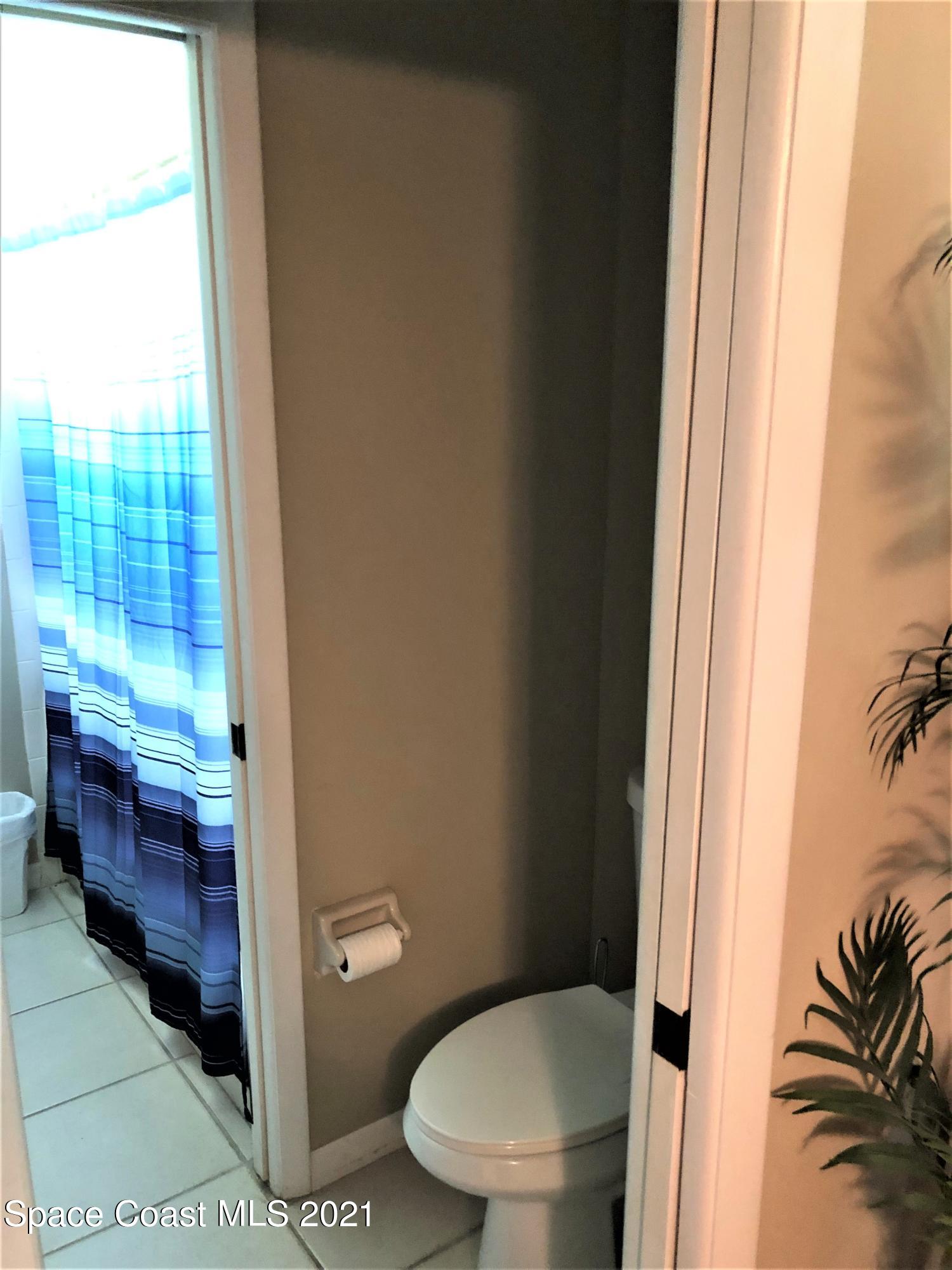 655 Ridge Club Drive, Unit 28 Melbourne, FL 32934 - Photo 8 of 12 Toilet and sink off of bedroom