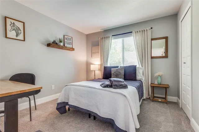 a bedroom with a bed a table and chair