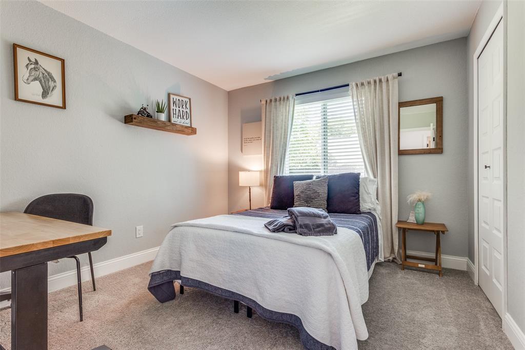 109 Mapleridge Drive Rockwall, TX 75032 - Photo 14 of 16 a bedroom with a bed a table and chair