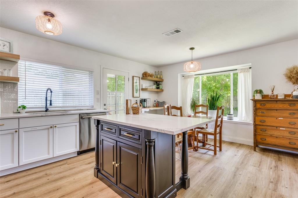 109 Mapleridge Drive Rockwall, TX 75032 - Photo 7 of 16 a kitchen with a table chairs and wooden floor