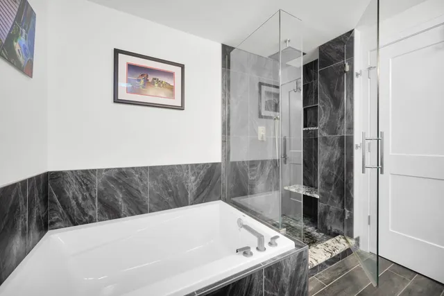 a bathroom with a tub and a shower