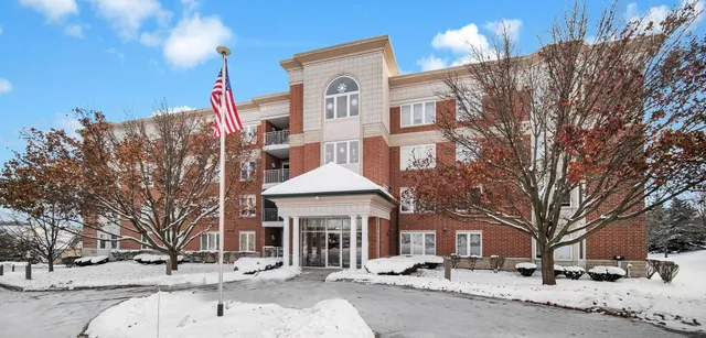 a front view of a building with snow on the road