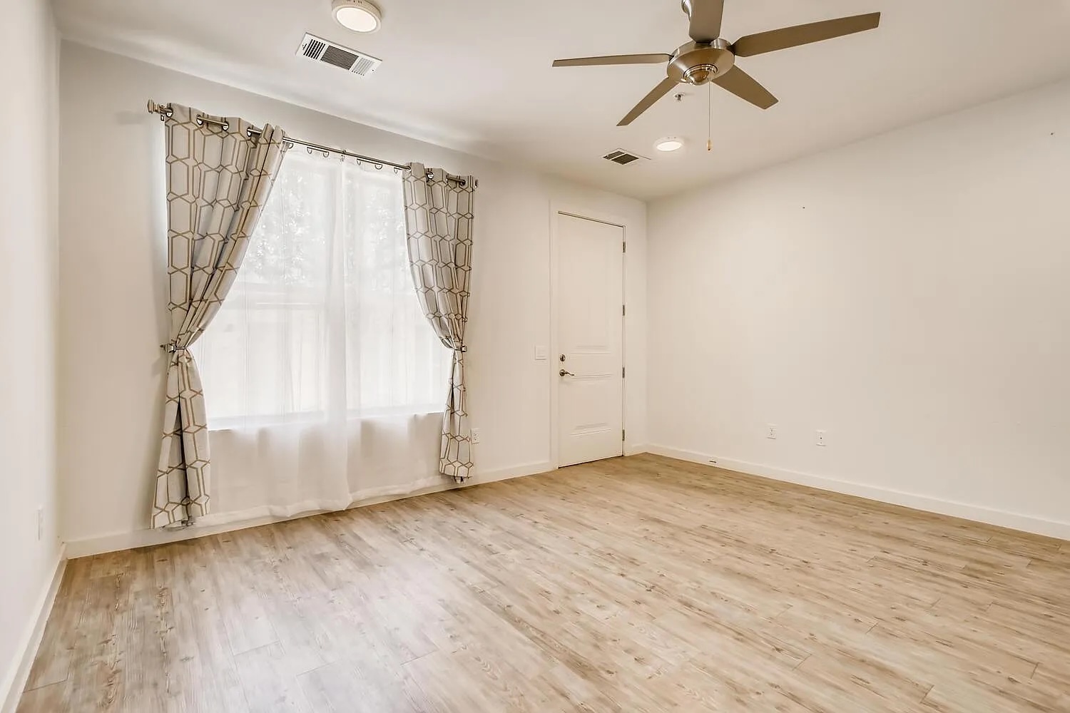 7805 Cooper Lane, Unit 206 Austin, TX 78745 - Photo 2 of 13 A quiet living area offers light wood-style flooring and a ceiling fan for year-round comfort.