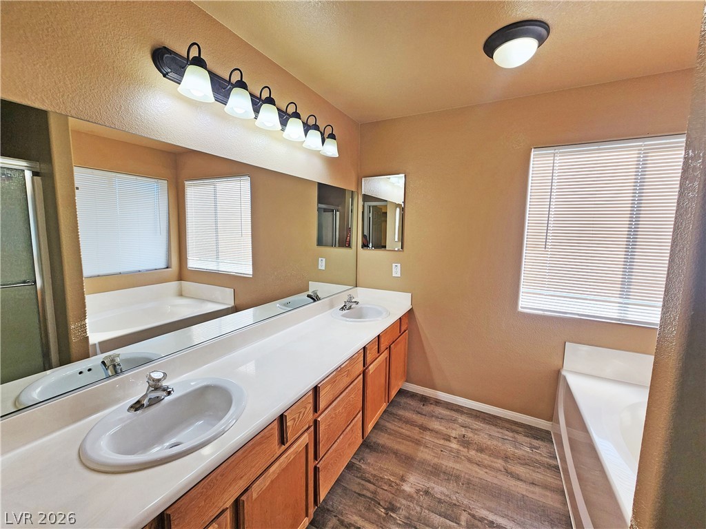 3680 Ravine Avenue Pahrump, NV 89048 - Photo 15 of 28 Full bath with wood finished floors, a garden tub, and a sink