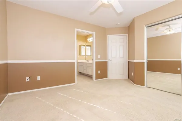 an empty room with closet and windows