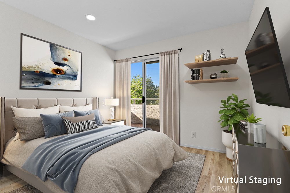 21921 Rimhurst Drive, Unit 128 Lake Forest, CA 92630 - Photo 13 of 24 a bedroom with a bed and a painting on the wall