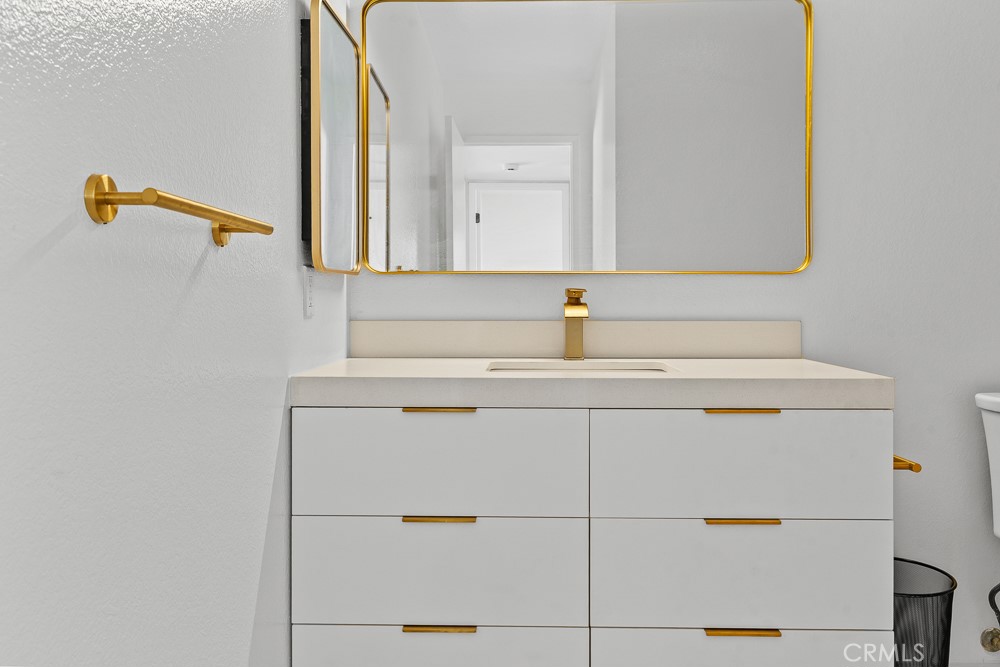 21921 Rimhurst Drive, Unit 128 Lake Forest, CA 92630 - Photo 16 of 24 a bathroom with a sink and a mirror