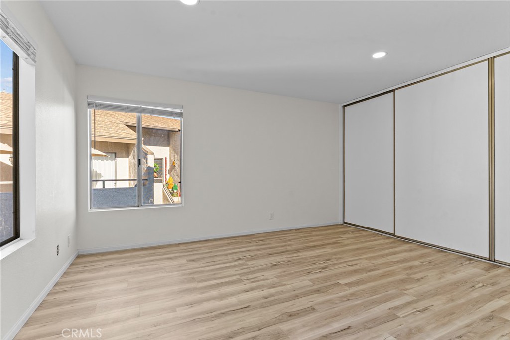 21921 Rimhurst Drive, Unit 128 Lake Forest, CA 92630 - Photo 21 of 24 a view of an empty room with wooden floor and a window