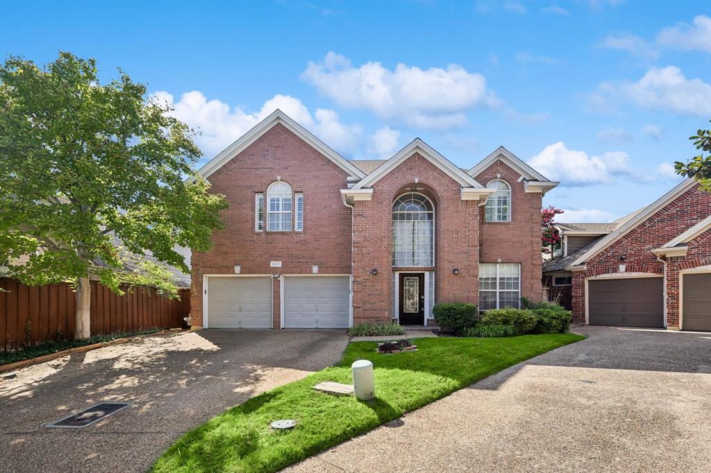 14625 Windsor Court Addison, TX 75001 - Photo 1 of 40 a front view of a house with a yard and garage
