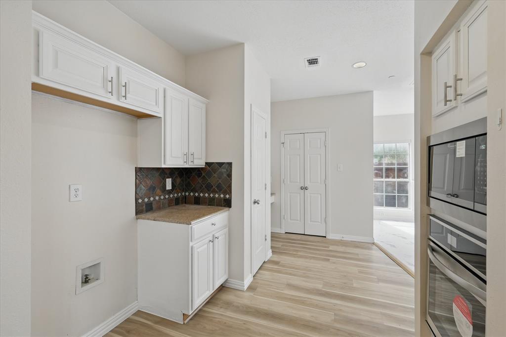 14625 Windsor Court Addison, TX 75001 - Photo 12 of 40 a kitchen with granite countertop a refrigerator and a stove top oven