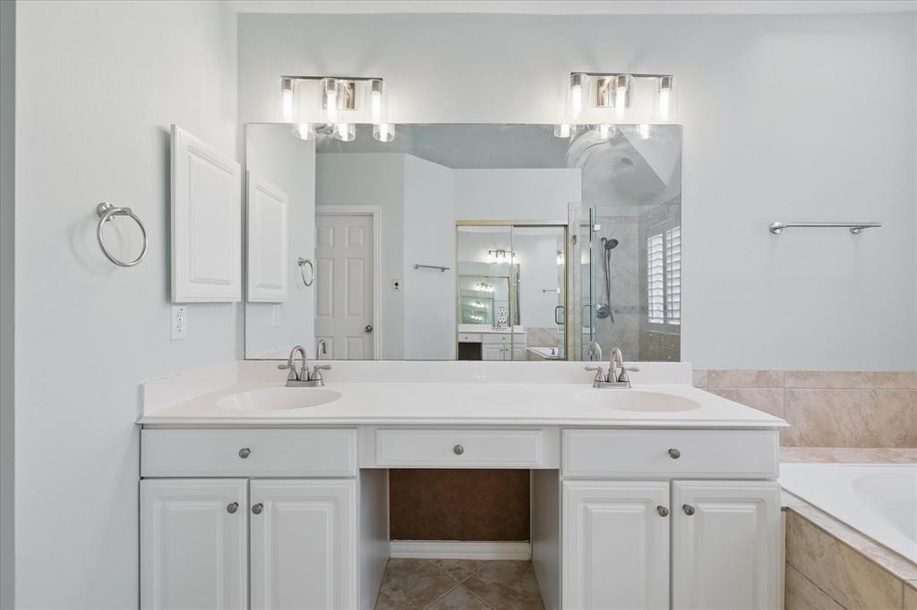 14625 Windsor Court Addison, TX 75001 - Photo 23 of 40 a bathroom with a sink vanity and a mirror