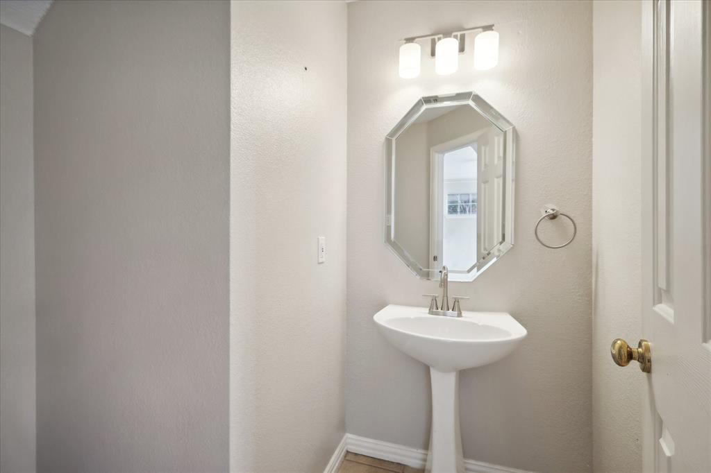 14625 Windsor Court Addison, TX 75001 - Photo 29 of 40 a bathroom with a sink and a mirror