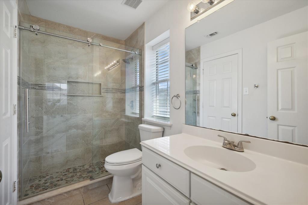 14625 Windsor Court Addison, TX 75001 - Photo 31 of 40 a bathroom with a sink toilet and shower