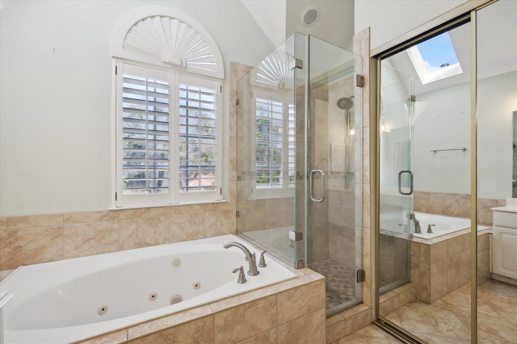 14625 Windsor Court Addison, TX 75001 - Photo 34 of 40 a bathroom with a tub a sink and a shower