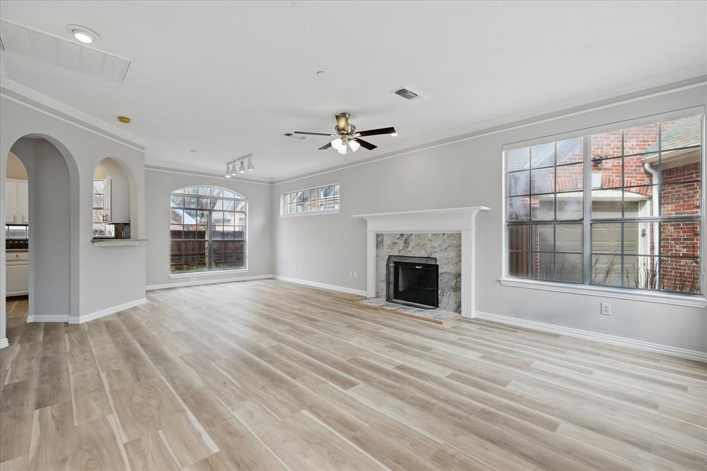 14625 Windsor Court Addison, TX 75001 - Photo 4 of 40 a view of an empty room with a fireplace and a window