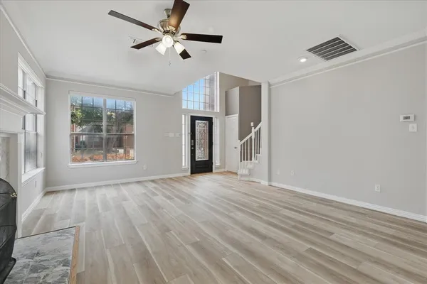 wooden floor in an empty room with a window