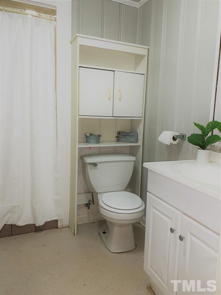 464 Rose Lane Raleigh, NC 27610 - Photo 3 of 5 a bathroom with a toilet a sink and a mirror