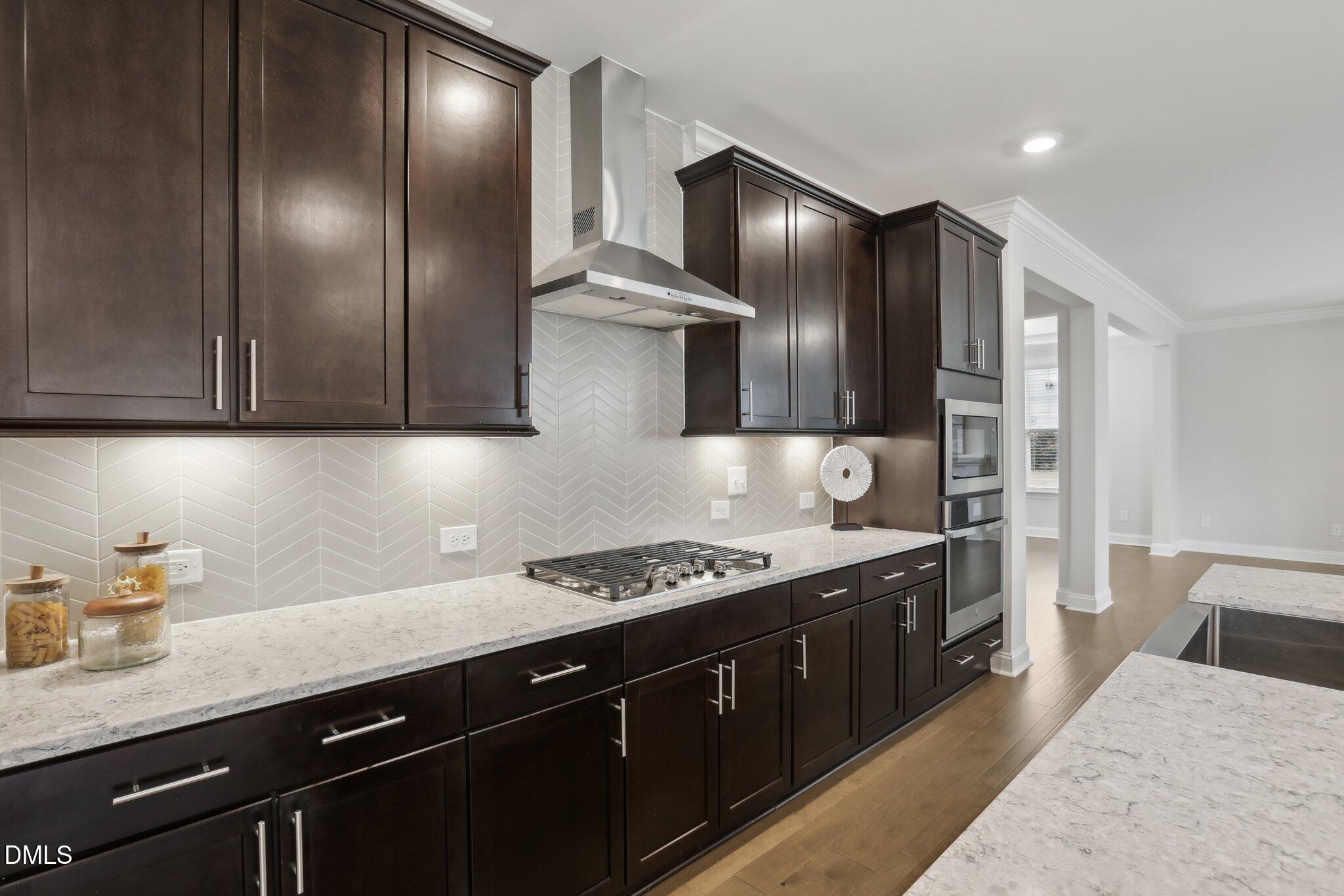 1829 Knights Crest Way Wake Forest, NC 27587 - Photo 15 of 45 a kitchen with stainless steel appliances granite countertop a sink stove and cabinets