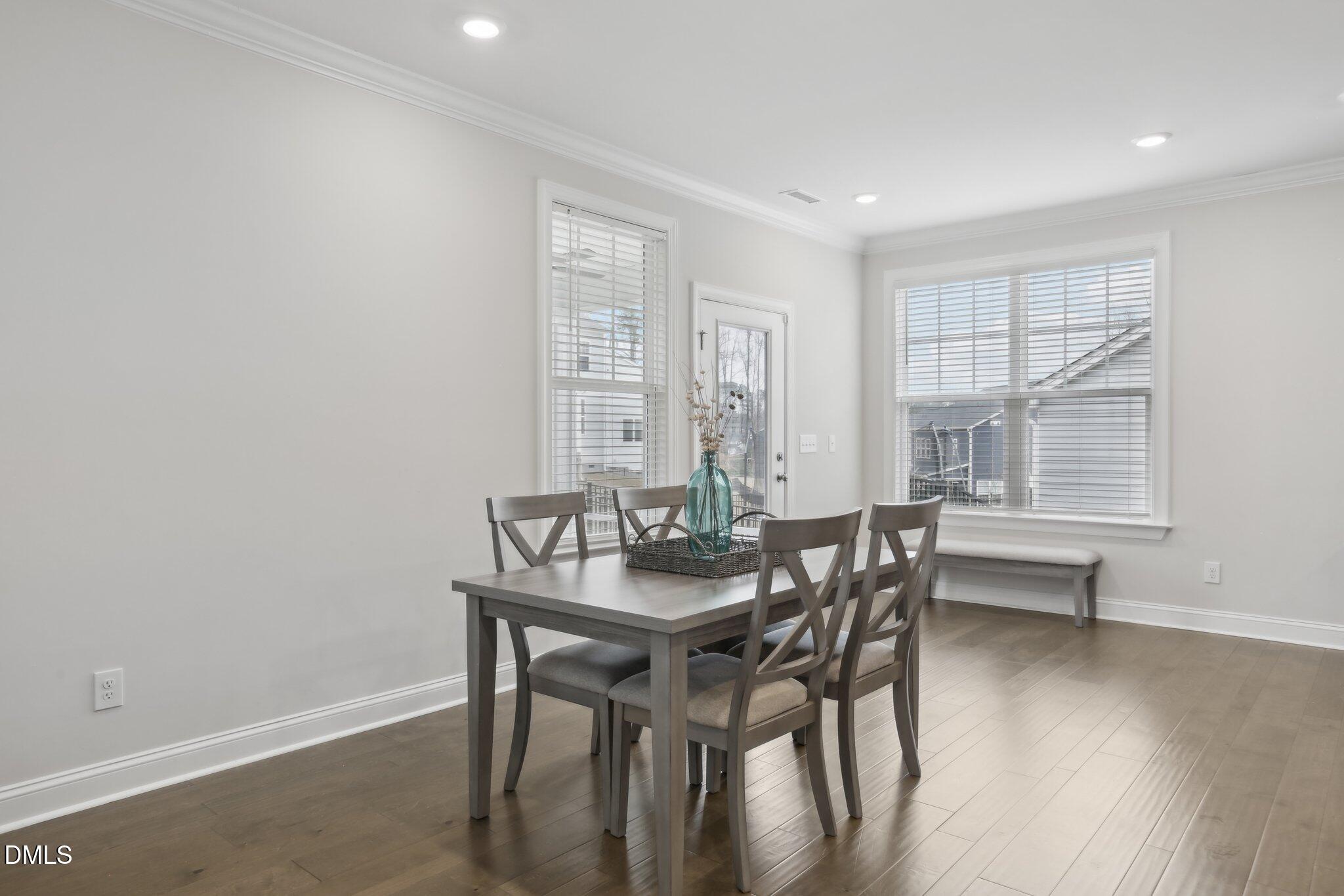1829 Knights Crest Way Wake Forest, NC 27587 - Photo 17 of 45 a dining room with furniture and wooden floor