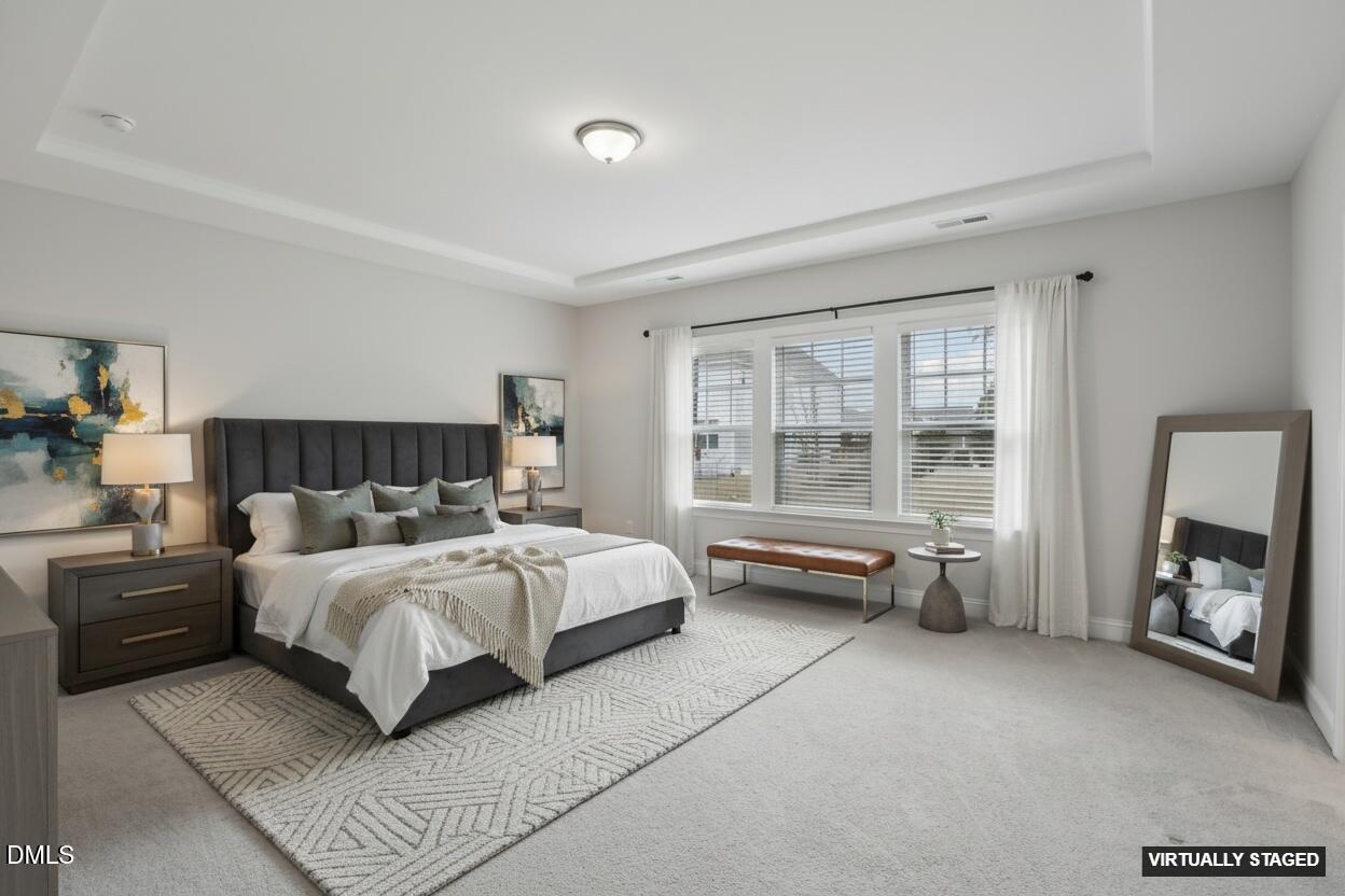 1829 Knights Crest Way Wake Forest, NC 27587 - Photo 26 of 45 a spacious bedroom with a bed and a couch