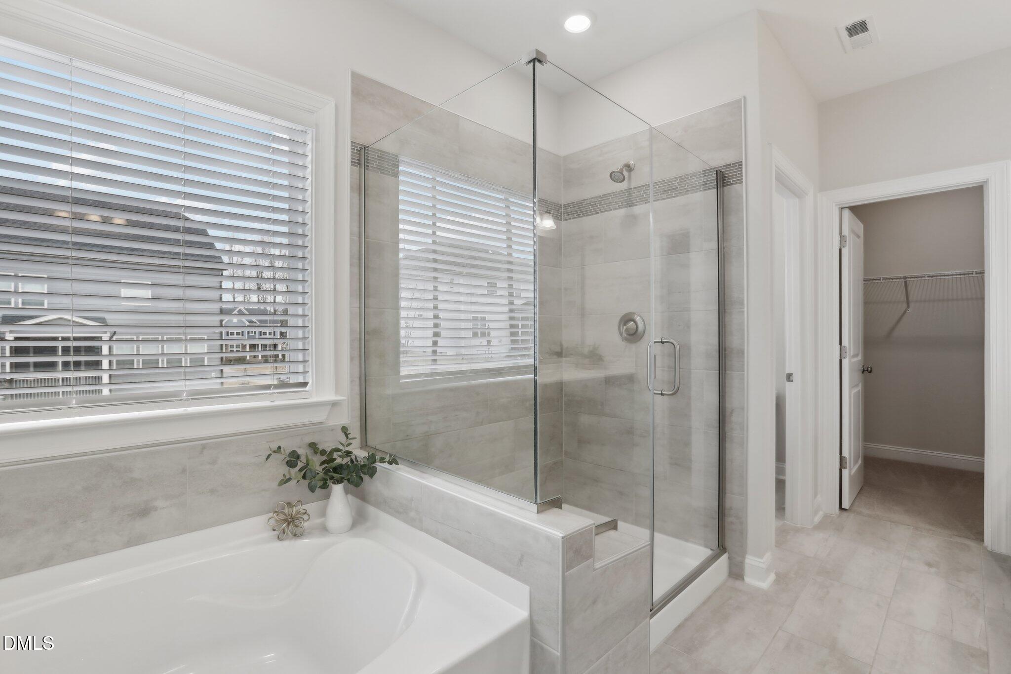 1829 Knights Crest Way Wake Forest, NC 27587 - Photo 30 of 45 a bathroom with a bathtub and a shower