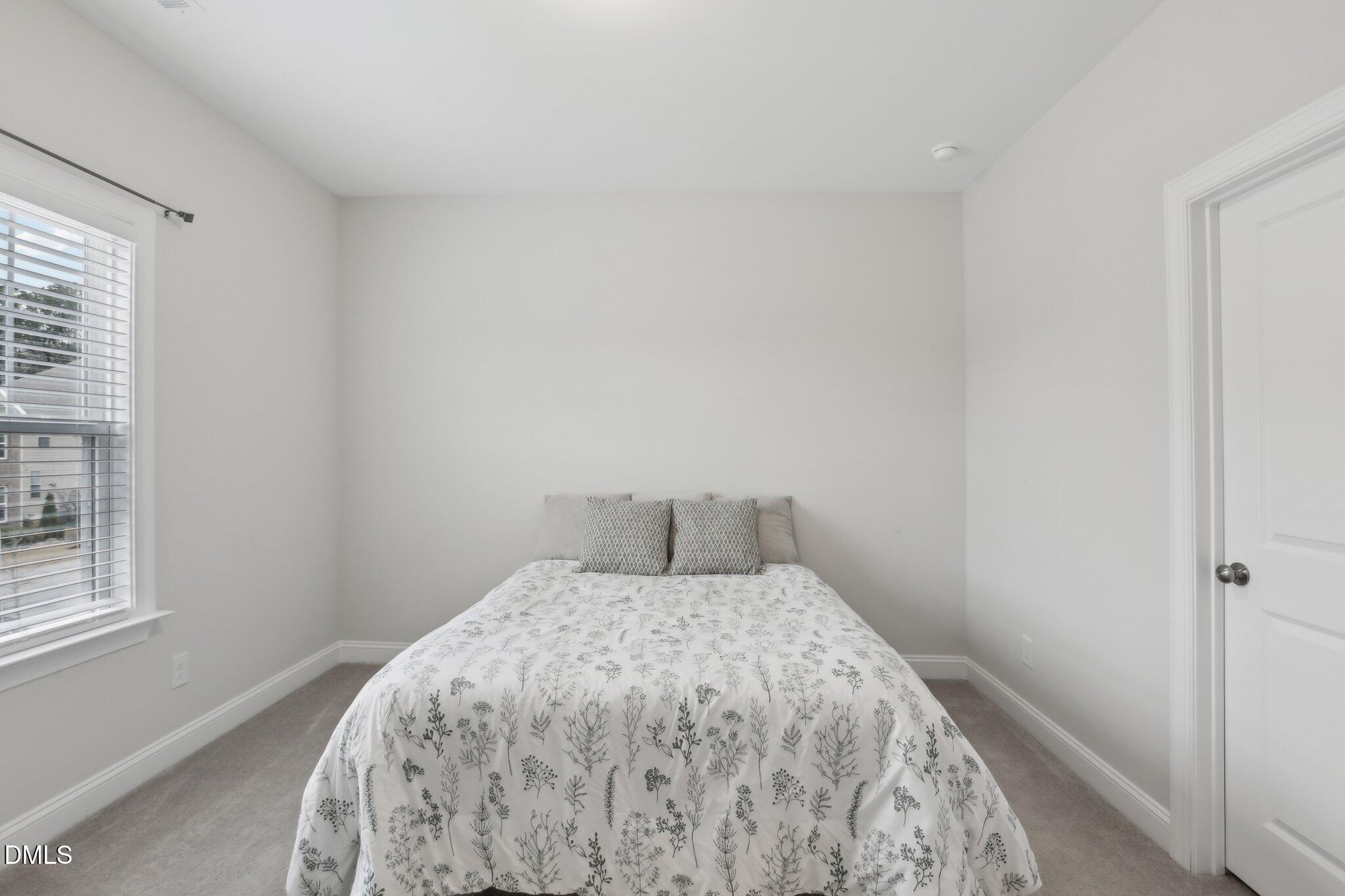 1829 Knights Crest Way Wake Forest, NC 27587 - Photo 31 of 45 a bedroom with a bed and a window