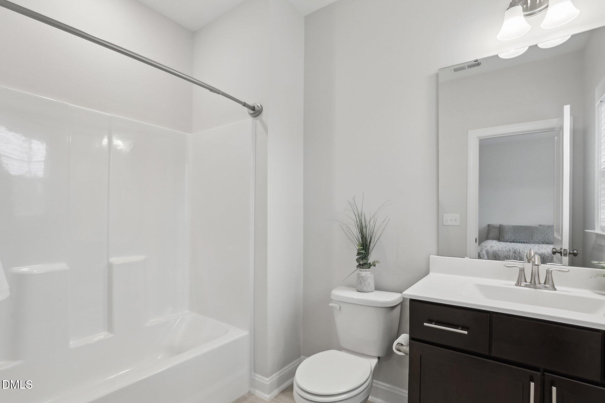 1829 Knights Crest Way Wake Forest, NC 27587 - Photo 32 of 45 a bathroom with a sink a toilet and shower