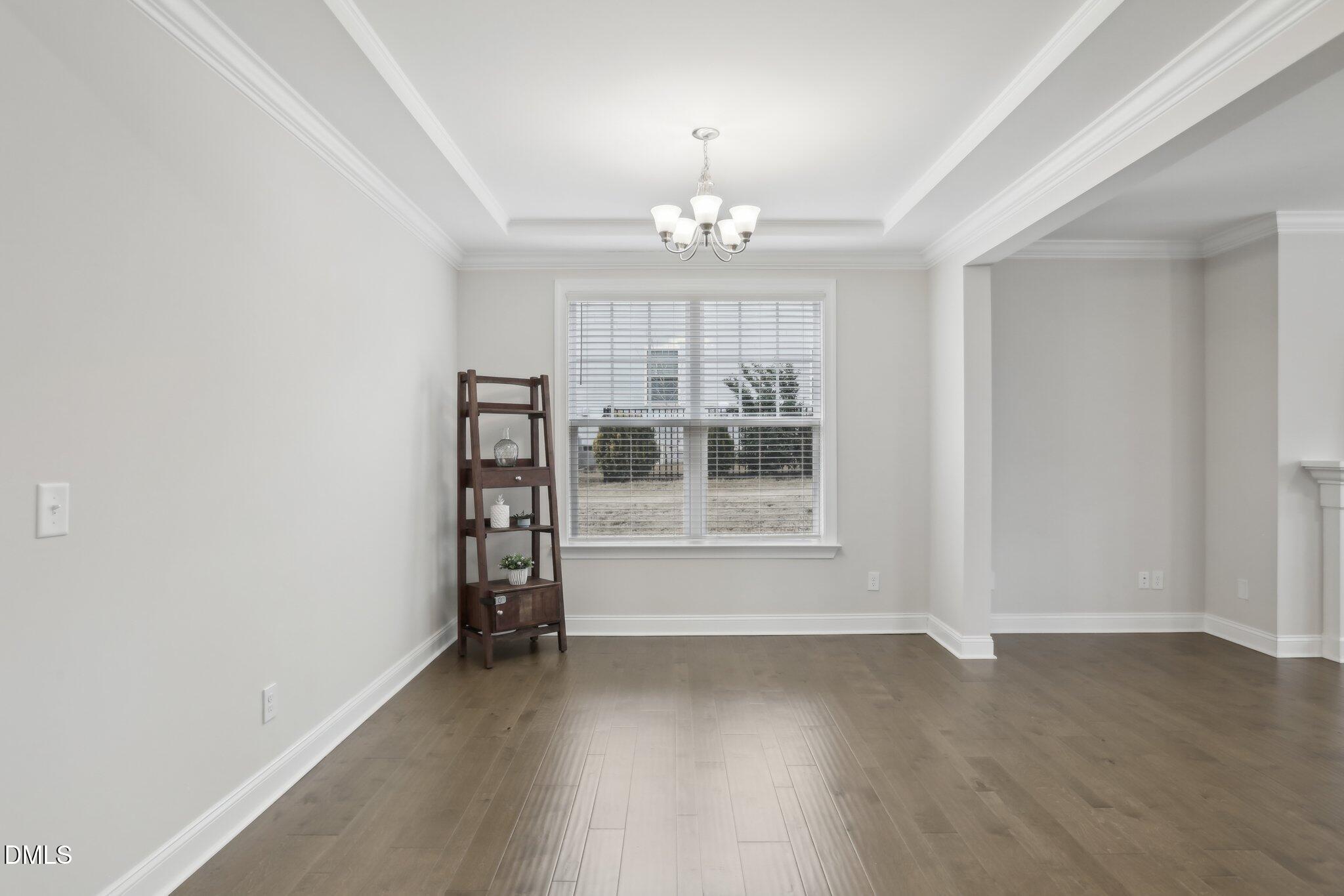 1829 Knights Crest Way Wake Forest, NC 27587 - Photo 6 of 45 wooden floor in an empty room with a window
