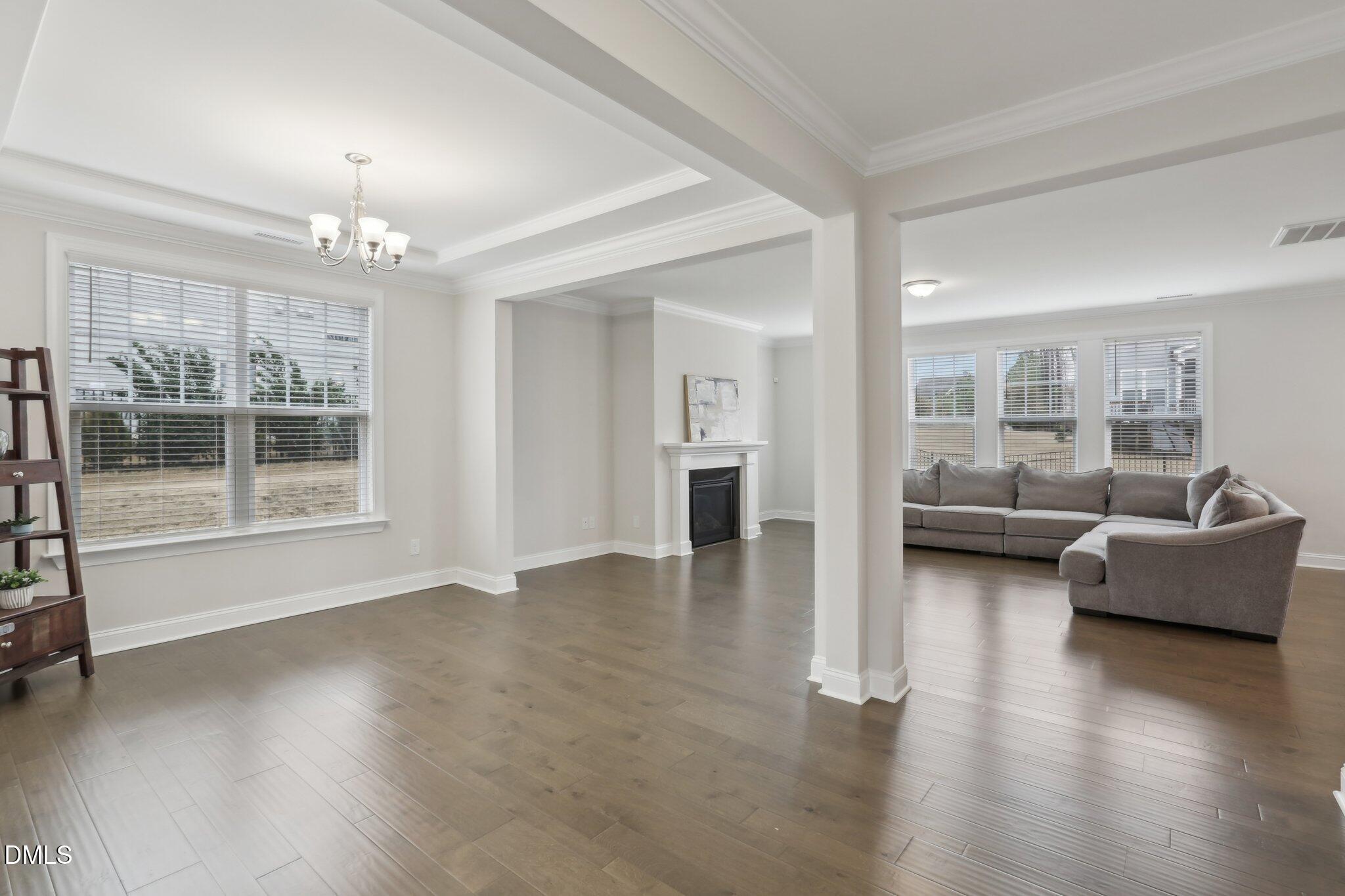 1829 Knights Crest Way Wake Forest, NC 27587 - Photo 8 of 45 a living room with furniture and a chandelier