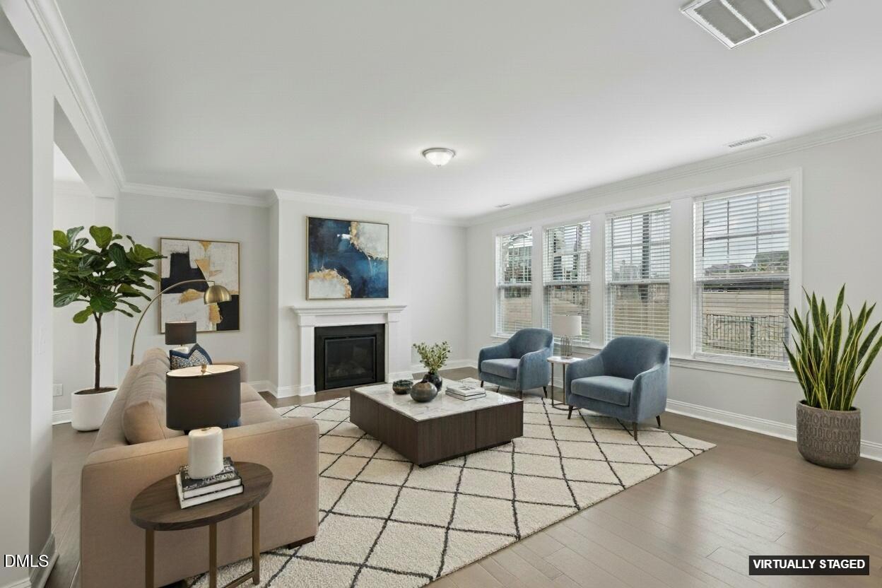 1829 Knights Crest Way Wake Forest, NC 27587 - Photo 9 of 45 a living room with furniture a fireplace and a potted plant