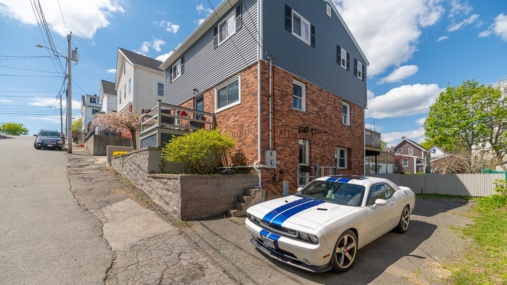 9 Alpine Court Gloucester, MA 01930 - Photo 5 of 32 a car parked in front of a brick building