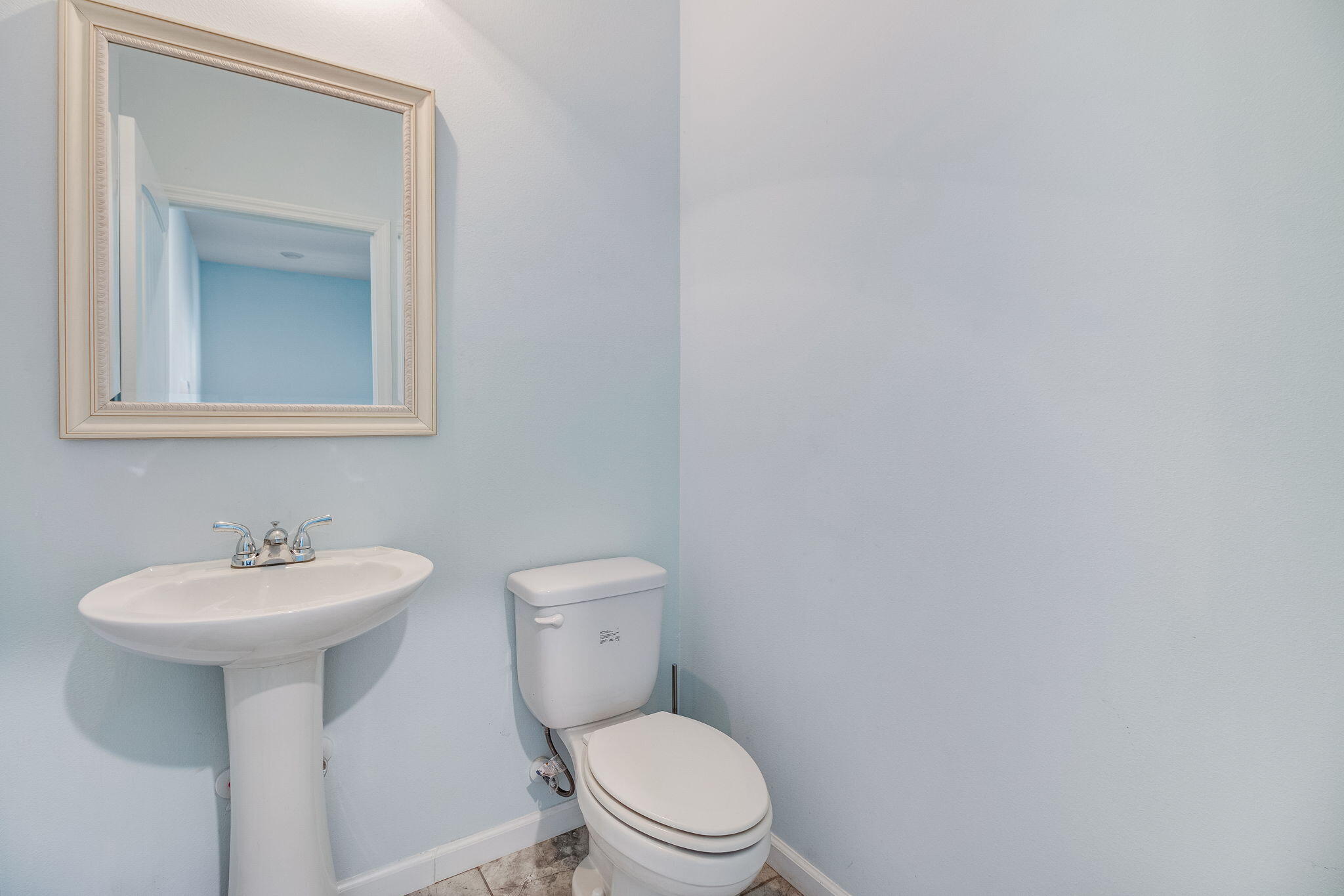 189 Johnson Court Crestview, FL 32536 - Photo 9 of 20 a bathroom with a toilet sink and mirror