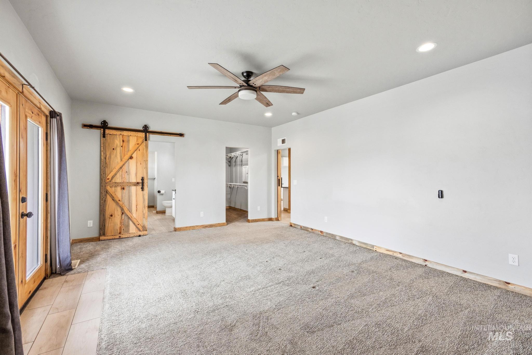 870 Desert Wind Road Boise, ID 83716 - Photo 17 of 50 Spacious interior room featuring light gray carpeting and light wood trim