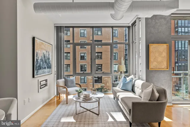 a living room with furniture and a floor to ceiling window