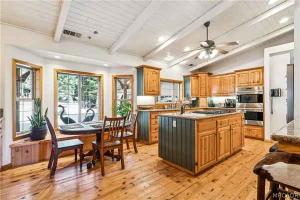 a kitchen with stainless steel appliances a sink stove and cabinets