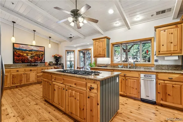 a large kitchen with a table and chairs