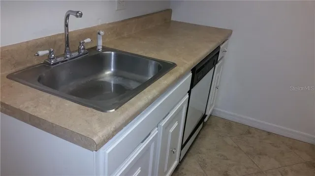 a stove top oven sitting inside of a kitchen