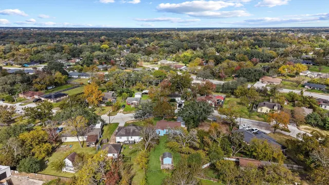 an aerial view of residential building with green space
