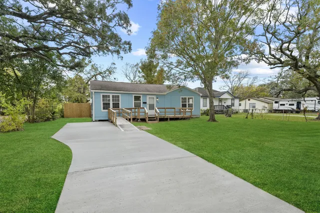 a view of house with outdoor space and garden