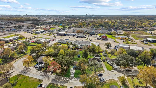 a view of a house with a backyard and a tree