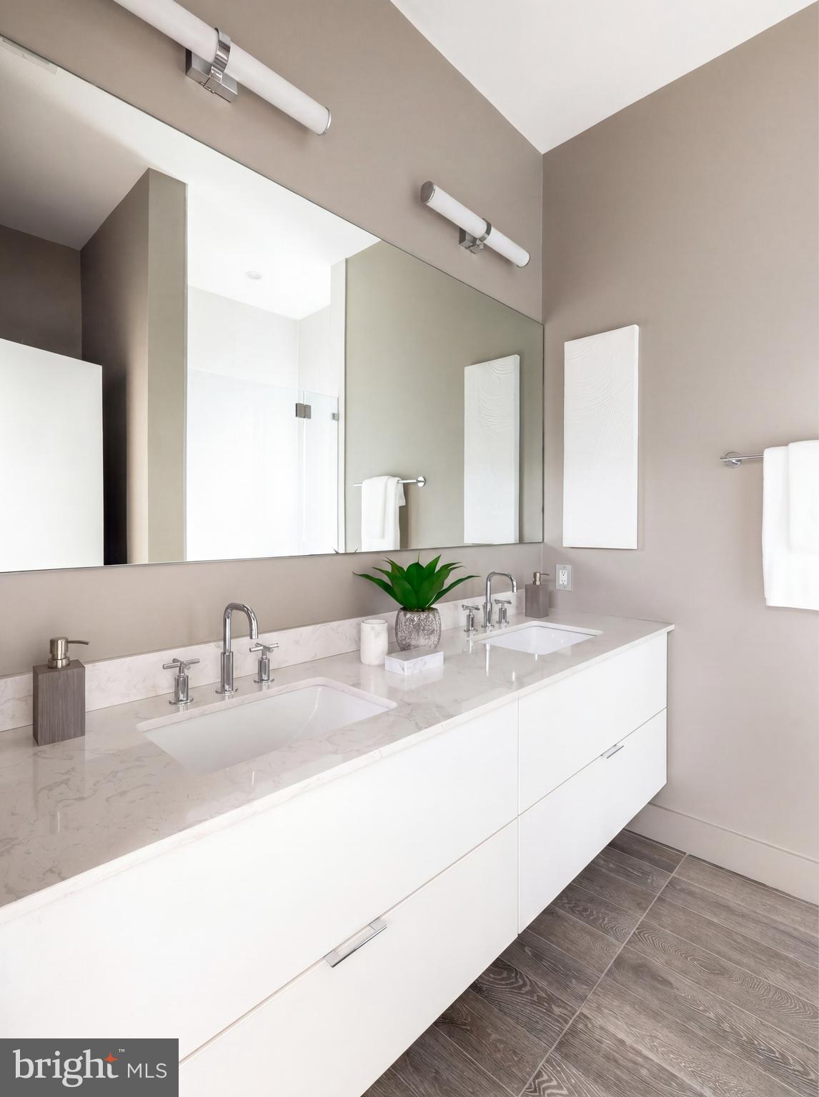 1522 Foxhall Road Northwest Washington, DC 20007 - Photo 36 of 47 a bathroom with double vanity sinks and a mirror