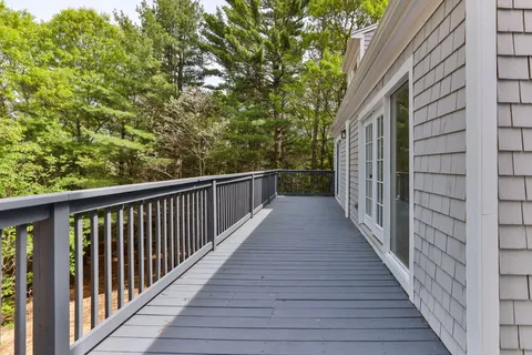 a view of a balcony with wooden floor