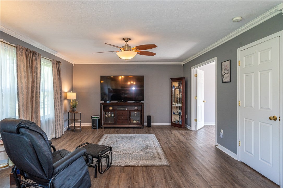 10765 Stone Ridge Way Harrison, OH 45030 - Photo 10 of 68 A well-proportioned living room featuring a warm wood-look floor and graceful crown molding.